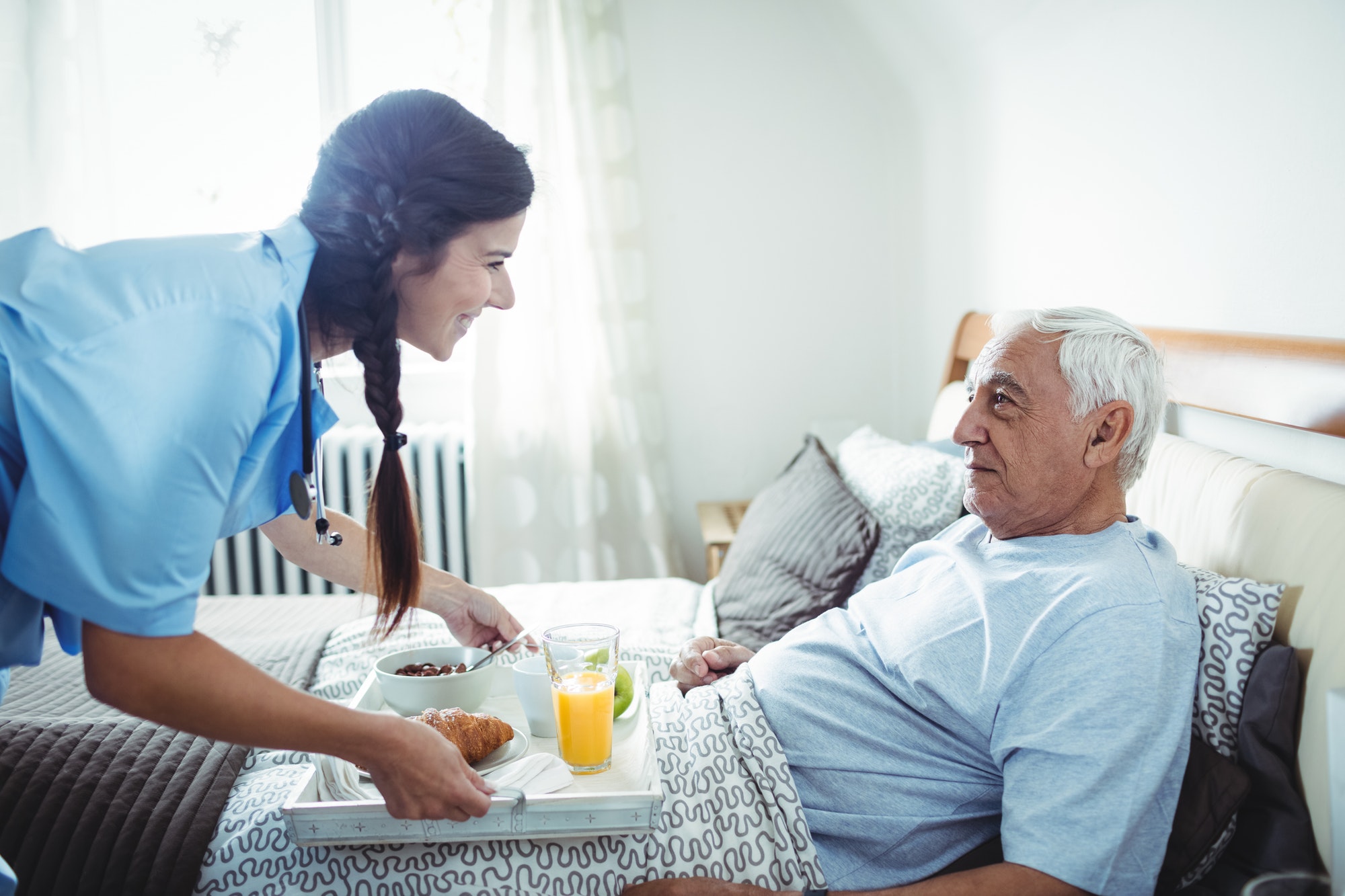 nurse-serving-breakfast-to-senior-man.jpg